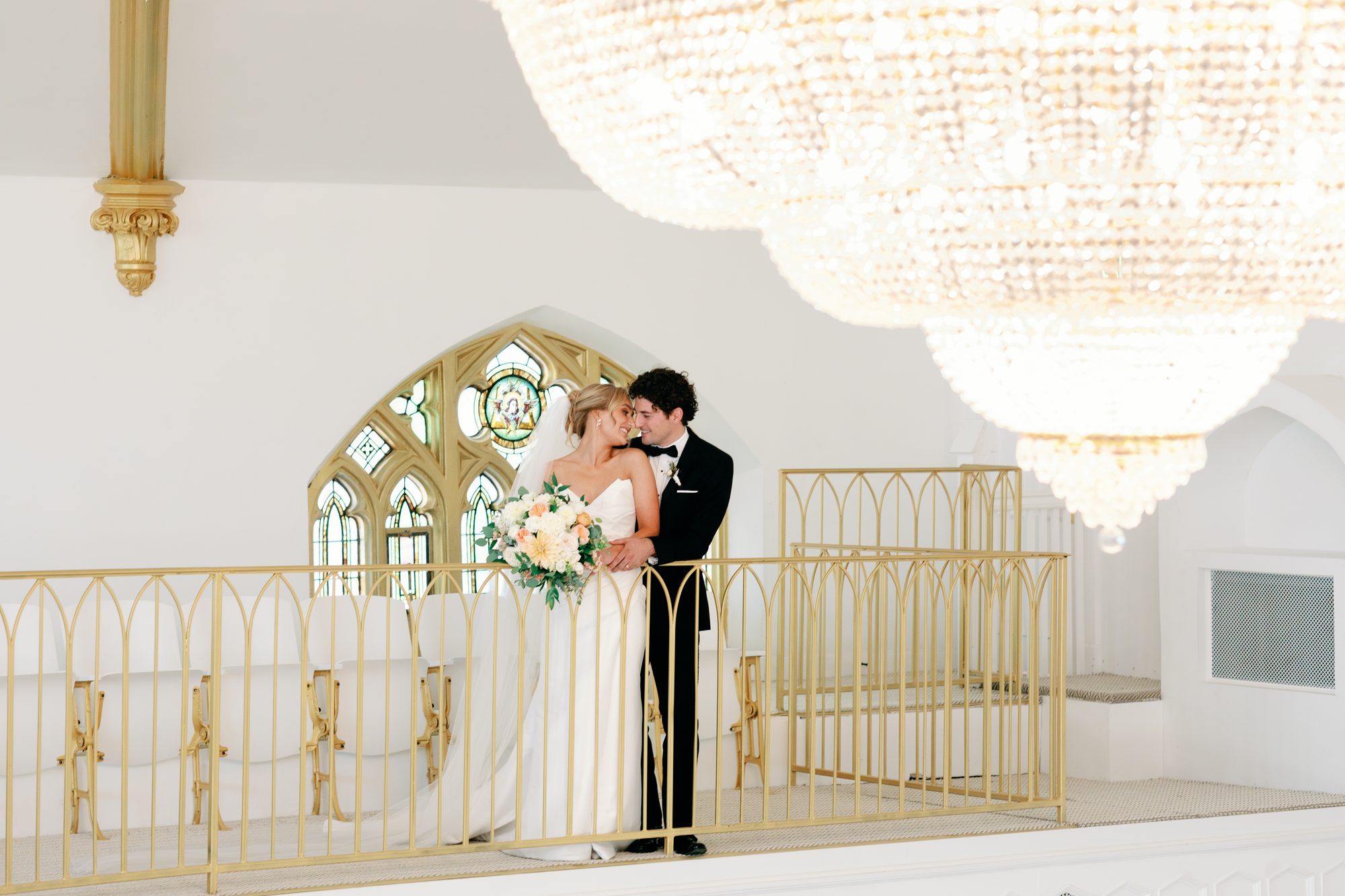 Couple portrait beneath the arches of the restored 1922 church
